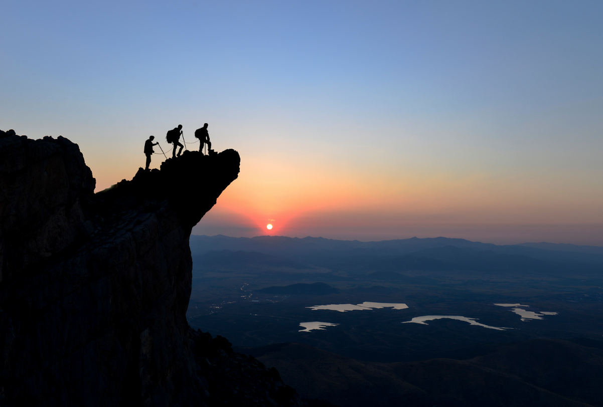 Hikers with determination reaching a peak